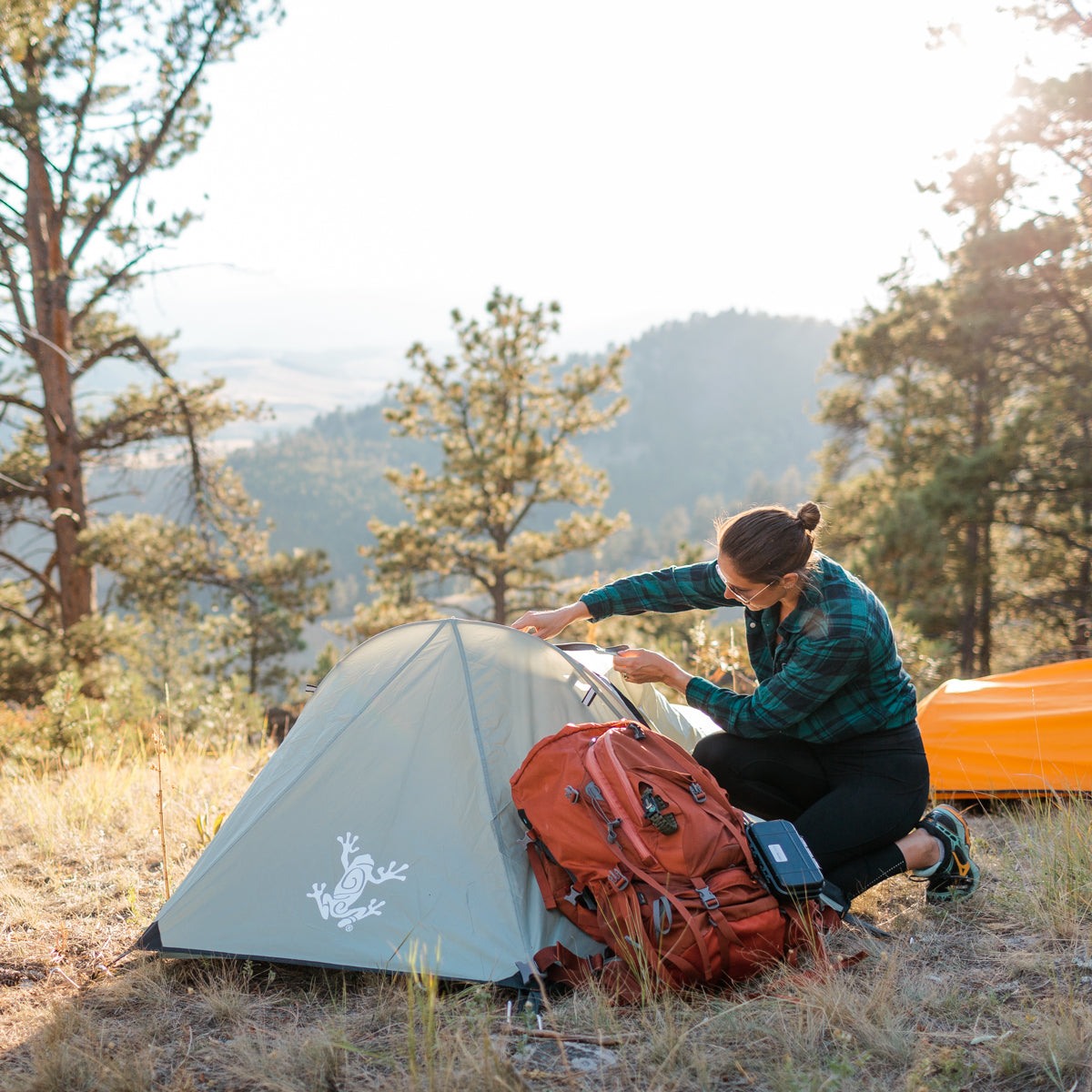 Orange Solo Bivy 1-Person Tent set up outdoors with waterproof rain fly and aluminum poles