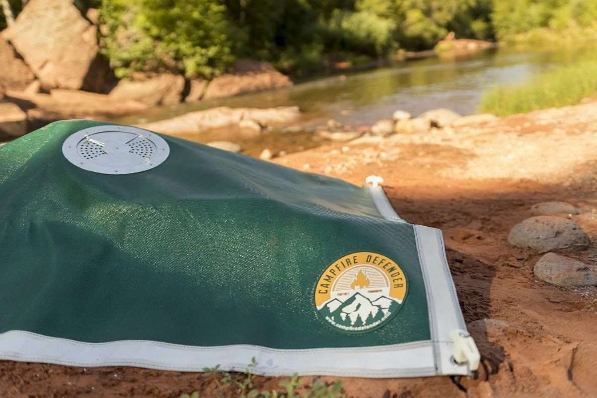 Campfire Defender kit with cover, carrying bag, fire stakes, gloves, tent stakes, and flashlight