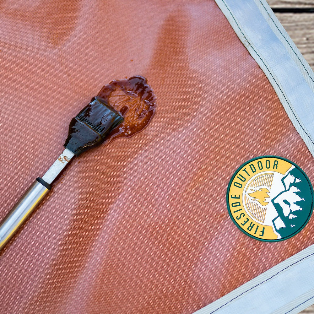 Ground Ember Mat protecting patio from embers and grease drips under fire pit with reflective edges and grommets