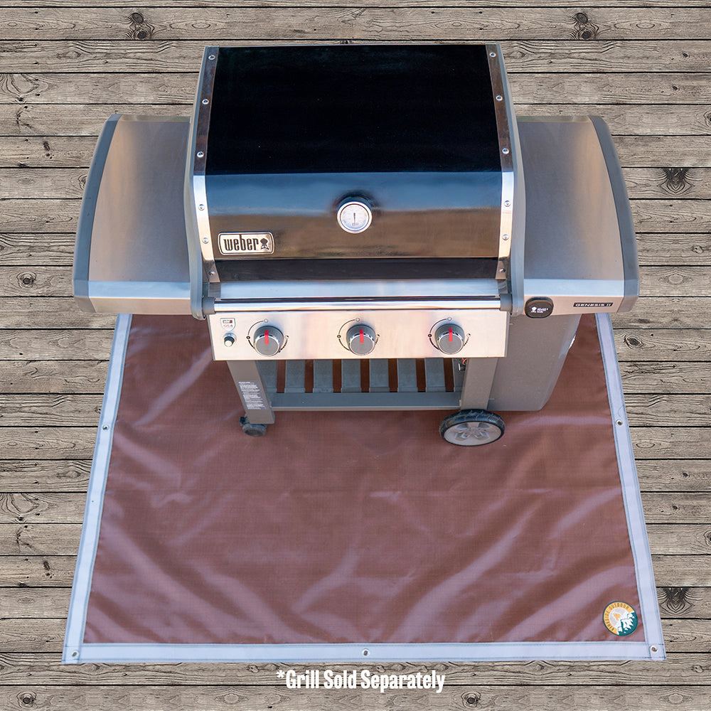 Ground Ember Mat protecting ground from embers and grease under fire pit and grill