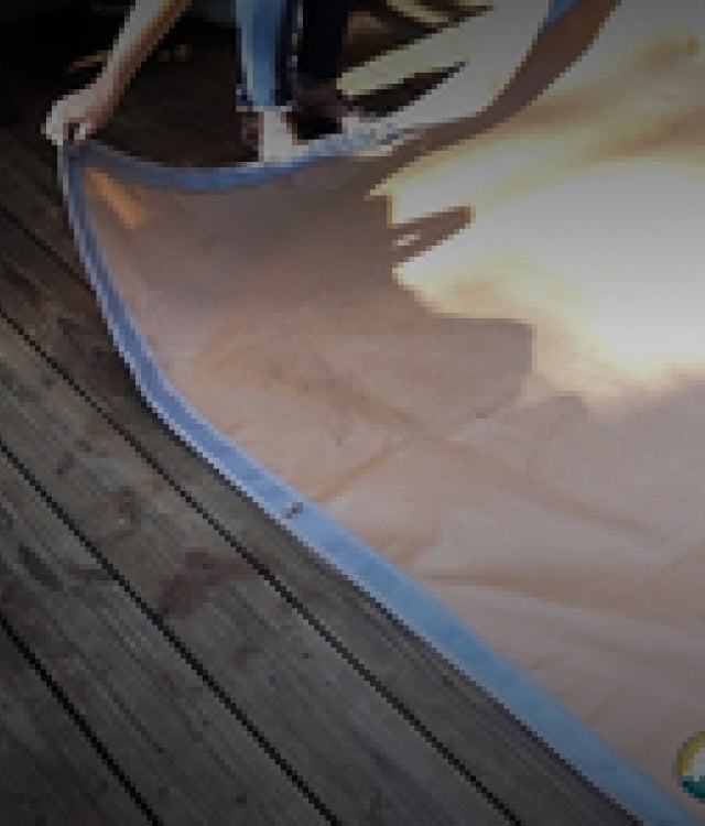 Ground Ember Mat protecting patio from embers and grease near fire pit