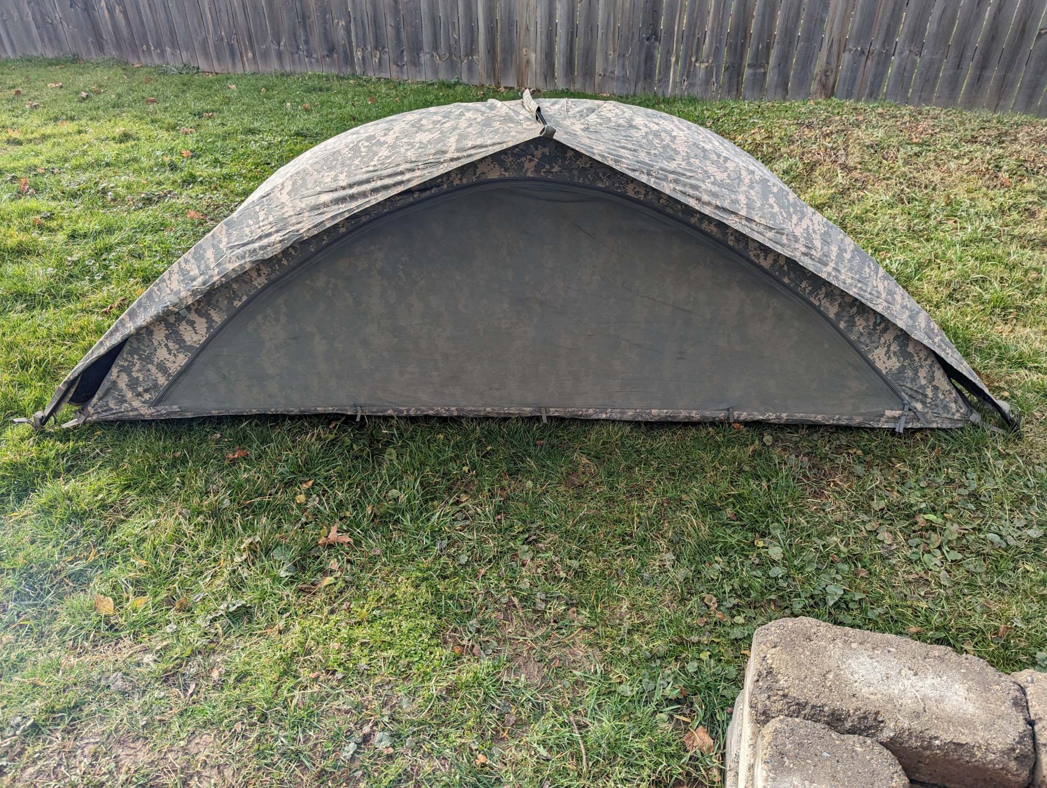 U.S. Military Improved Combat Shelter in ACU digital camouflage with waterproof breathable fabric and lightweight aluminum poles set up outdoors