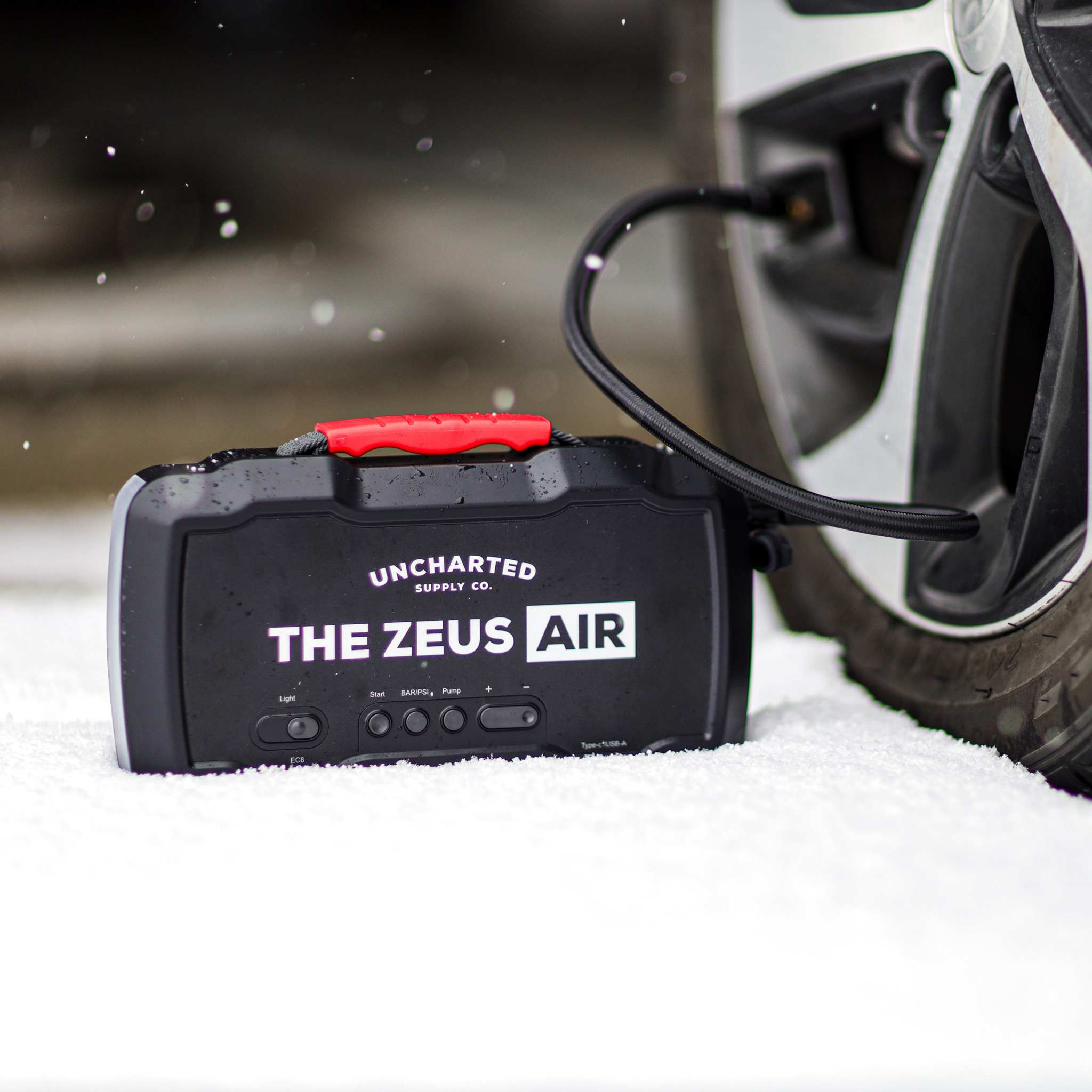 Compact Zeus Air Jump Starter with 150 PSI inflator, 15,000 mAh battery, USB charging, and LED emergency light